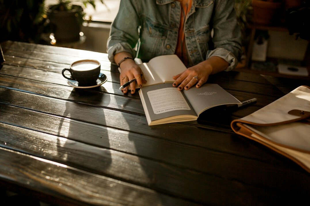 person writing in journal morning