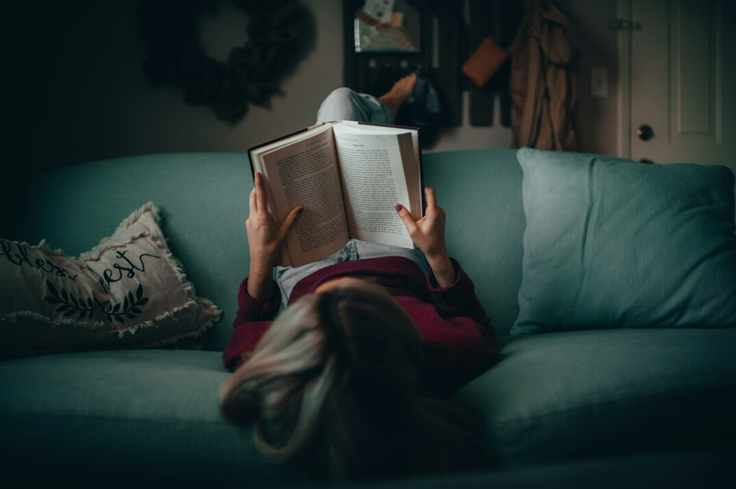 person reading book at home